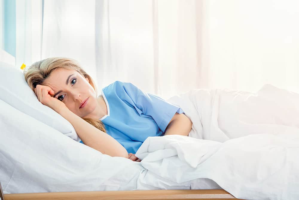 Woman-laying-in-hospital-bed